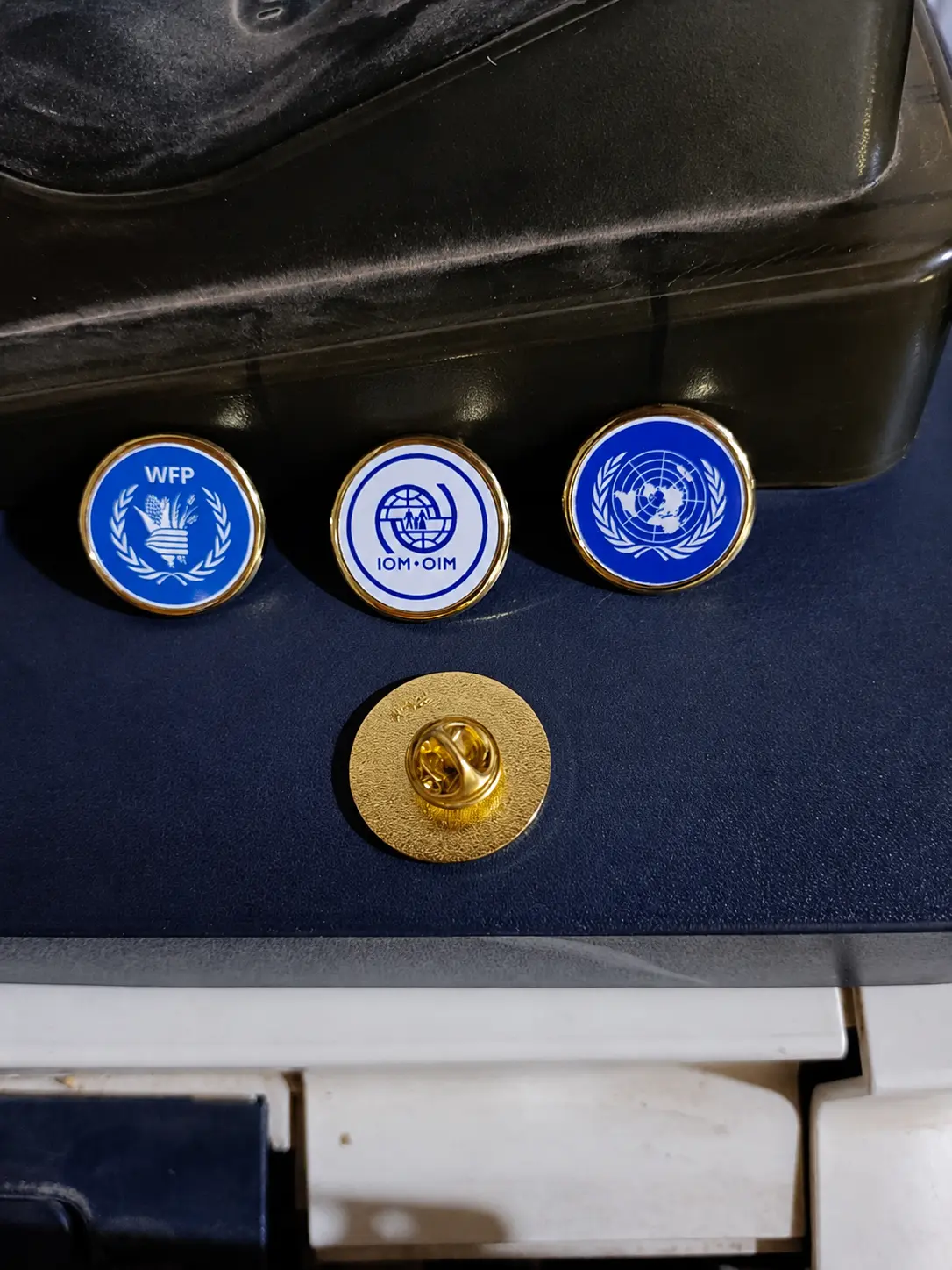 Pin's institutionnels WFP / OIM / ONU